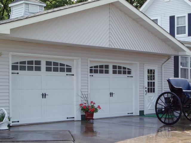 white carriage garage doors with black handles 